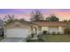 Charming single-story home with a manicured lawn and attached two-car garage at 206 Memphis Pl, St Cloud, FL 34769
