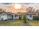 Charming single-story home featuring a well-maintained lawn, mature landscaping, and an attached two-car garage at 206 Memphis Pl, St Cloud, FL 34769