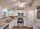 Well-lit kitchen showcasing white cabinetry, granite countertops, stainless steel appliances, and a view to the outdoors at 206 Memphis Pl, St Cloud, FL 34769