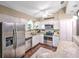 Bright kitchen featuring stainless steel appliances, granite countertops, stylish barstool seating, and ample cabinet space at 206 Memphis Pl, St Cloud, FL 34769
