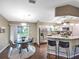 Kitchen and breakfast nook showcasing an open floor plan, granite countertops, stainless steel appliances, and a breakfast table at 206 Memphis Pl, St Cloud, FL 34769
