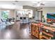 Open concept living space featuring dark wood floors, modern furniture, bar seating, and lots of natural light at 206 Memphis Pl, St Cloud, FL 34769