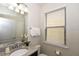 Small bathroom with granite countertop and single sink vanity at 2112 Morocco Way, Kissimmee, FL 34747