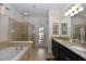 Main bathroom with granite countertops, soaking tub, and walk-in shower at 2112 Morocco Way, Kissimmee, FL 34747