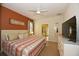 Large bedroom with king-size bed, TV, and ensuite bathroom access at 2112 Morocco Way, Kissimmee, FL 34747