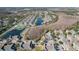 Overhead view of a neighborhood highlighting water features, mature trees, and recreational facilities at 2203 San Vittorino Cir # 107, Kissimmee, FL 34741