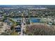 Scenic aerial view of a neighborhood featuring ponds, tennis courts, and well-maintained landscaping at 2203 San Vittorino Cir # 107, Kissimmee, FL 34741