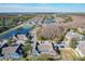 Picturesque aerial view showcasing community amenities, including a swimming pool, tennis court, and tranquil ponds at 2203 San Vittorino Cir # 107, Kissimmee, FL 34741
