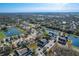 Expansive aerial view of a residential area featuring townhomes, lakes, and lush greenery under a clear blue sky at 2203 San Vittorino Cir # 107, Kissimmee, FL 34741
