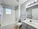 Bathroom features a tub/shower, tile floor, and large mirror at 2203 San Vittorino Cir # 107, Kissimmee, FL 34741