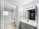 Bright bathroom features a large mirror, vanity with storage, and a shower/tub combo at 2203 San Vittorino Cir # 107, Kissimmee, FL 34741