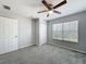 Bedroom features a window, ceiling fan, carpet, and a closet at 2203 San Vittorino Cir # 107, Kissimmee, FL 34741