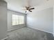 Bedroom with a large window, ceiling fan, and carpeted flooring at 2203 San Vittorino Cir # 107, Kissimmee, FL 34741