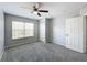 Neutral bedroom with a large window, closet, and ceiling fan at 2203 San Vittorino Cir # 107, Kissimmee, FL 34741
