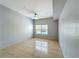 Bedroom featuring tile floors, neutral walls, and a ceiling fan at 2203 San Vittorino Cir # 107, Kissimmee, FL 34741