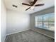Bedroom features a carpeted floor, ceiling fan, and a window at 2203 San Vittorino Cir # 107, Kissimmee, FL 34741