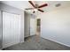 Neutral bedroom features a ceiling fan, closet, and door to another room at 2203 San Vittorino Cir # 107, Kissimmee, FL 34741