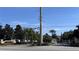 Community entrance featuring lush landscaping, trees, and shrubbery at 2203 San Vittorino Cir # 107, Kissimmee, FL 34741