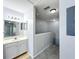 Bathroom vanity leads into a hallway with stairs at 2203 San Vittorino Cir # 107, Kissimmee, FL 34741
