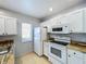 Bright kitchen with white appliances and butcher block countertops at 2203 San Vittorino Cir # 107, Kissimmee, FL 34741