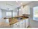 Kitchen with butcher block counters open to living room at 2203 San Vittorino Cir # 107, Kissimmee, FL 34741