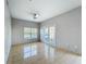 Living room featuring tile floors, a ceiling fan, and a set of glass doors at 2203 San Vittorino Cir # 107, Kissimmee, FL 34741