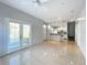 Living room featuring tile floors and connecting to the kitchen with white appliances at 2203 San Vittorino Cir # 107, Kissimmee, FL 34741