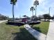 Charming community playground area complete with mature palms, lush landscaping, and ample seating at 2203 San Vittorino Cir # 107, Kissimmee, FL 34741