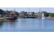 Inviting pond view showcasing the clubhouse, pool, and a fountain at 2203 San Vittorino Cir # 107, Kissimmee, FL 34741