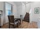 Bright dining area featuring a glass table, wood chairs, and staircase at 2979 Latitude Ln, Kissimmee, FL 34747