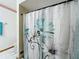 Bathroom highlighting a decorative shower curtain with a floral design and adjacent white tiles at 3039 China Berry Ct, Kissimmee, FL 34746