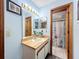 Bathroom featuring a vanity with a mirror, cabinet storage, and access to an additional bathroom at 3039 China Berry Ct, Kissimmee, FL 34746