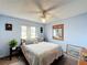 Bedroom showcasing a bed with accent pillows, carpeted floors, and natural light coming from a window at 3039 China Berry Ct, Kissimmee, FL 34746