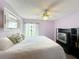 Bedroom highlighting a bed with a mirror, carpeted floors, and a television on a black shelving unit at 3039 China Berry Ct, Kissimmee, FL 34746