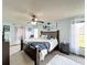 Spacious bedroom with a ceiling fan, a large bed, light blue walls and carpet flooring at 3039 China Berry Ct, Kissimmee, FL 34746