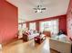 Inviting living area with bright walls, wood flooring, ample natural light, and elegant dining table set at 3039 China Berry Ct, Kissimmee, FL 34746