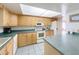 Well-maintained kitchen features light wood cabinets, functional layout, and ample counter space at 3039 China Berry Ct, Kissimmee, FL 34746