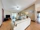 Open concept layout with spacious living room, wood floors, vaulted ceiling, and seamless flow to kitchen at 3039 China Berry Ct, Kissimmee, FL 34746