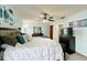Comfortable main bedroom featuring a ceiling fan, neutral wall color, and a large bed with cozy bedding at 3039 China Berry Ct, Kissimmee, FL 34746