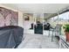 Enclosed screened patio with ample seating and a view to the backyard and neighboring properties at 3039 China Berry Ct, Kissimmee, FL 34746
