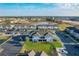 Aerial view shows a large neighborhood with a pond, townhomes, and plenty of parking at 361 Annabelle Way, Davenport, FL 33837