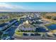 Community aerial showcasing condo buildings with ample parking, greenery, and a nearby pond at 361 Annabelle Way, Davenport, FL 33837