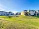 Backyard view shows a green lawn and back exterior with screened patios of home at 361 Annabelle Way, Davenport, FL 33837