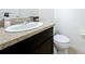 Bathroom featuring granite countertop vanity with modern fixtures and a white toilet at 361 Annabelle Way, Davenport, FL 33837