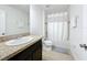 Well-lit bathroom features a granite countertop, tiled floors, and a shower-tub combo at 361 Annabelle Way, Davenport, FL 33837