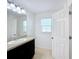 Bright bathroom featuring granite vanity top and a window that allows natural light at 361 Annabelle Way, Davenport, FL 33837