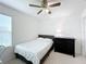 Cozy bedroom features a ceiling fan, comfortable bed, and side dresser at 361 Annabelle Way, Davenport, FL 33837