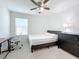 Bedroom with a bed, dresser, ceiling fan, and natural light at 361 Annabelle Way, Davenport, FL 33837