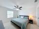 Bright bedroom with a ceiling fan, side table, and natural light at 361 Annabelle Way, Davenport, FL 33837