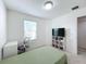 Minimalist bedroom featuring neutral-colored walls, a closet, and a large bright window at 361 Annabelle Way, Davenport, FL 33837